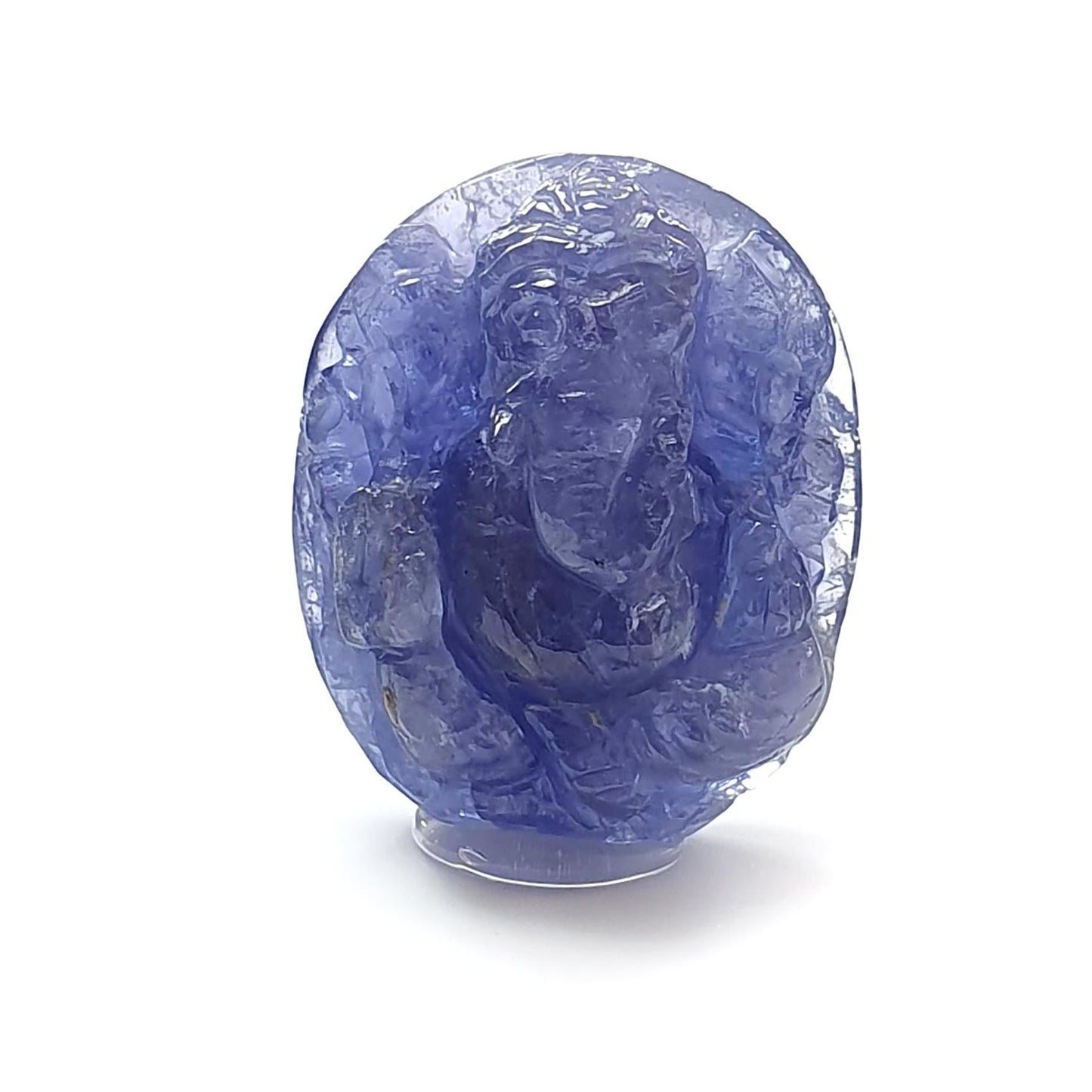 Blue gemstone with a face carving on a white background, branded 'Saksham Gems'.