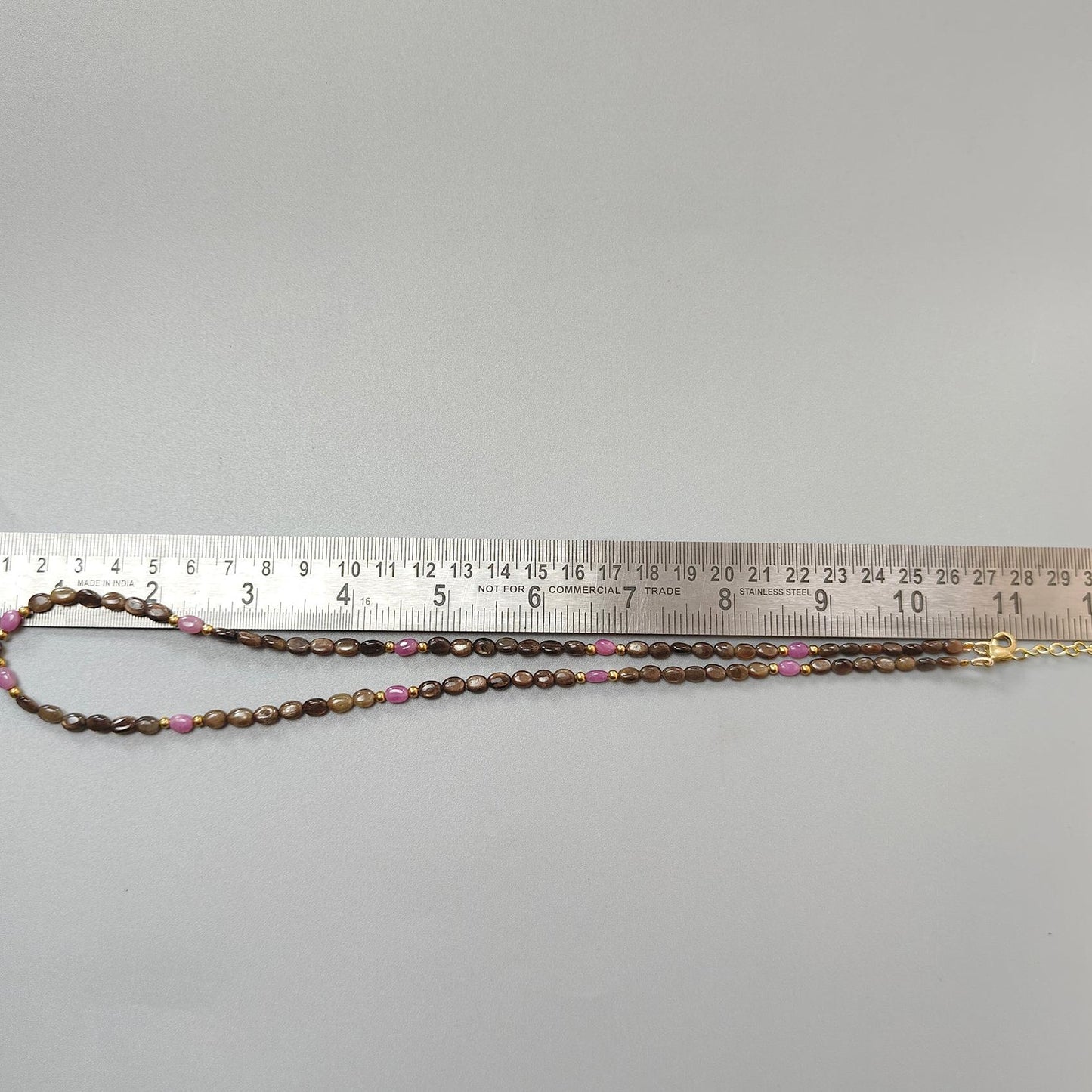 Golden & Pink Sapphire Oval Plain Brass Necklace: 18.04gms Golden & Pink Sapphire Oval Plain Brass Necklace 5*4mm-7*5mm ,10mm 21"( Apx)